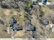 Aerial view of the property, showcasing the house, driveway, yard, surrounding neighborhood, and nearby trees at 6603 Iona Rd, Indianapolis, IN 46203