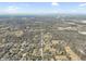 High aerial view of neighborhood showcasing residential layout and trees within the area. City in the distance at 6603 Iona Rd, Indianapolis, IN 46203