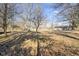 Large backyard with mature trees providing shade and privacy and view of the back of the house at 6603 Iona Rd, Indianapolis, IN 46203