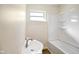 Bathroom showing a sink, a tub with shower, and a window at 6603 Iona Rd, Indianapolis, IN 46203