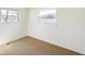 Bedroom featuring neutral carpet, with two windows providing bright natural light at 6603 Iona Rd, Indianapolis, IN 46203