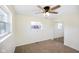 Bedroom showcasing neutral carpet, a ceiling fan, and closet with mirrored sliding doors at 6603 Iona Rd, Indianapolis, IN 46203