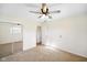 This bedroom shows neutral carpet, a ceiling fan, mirrored closet doors and an entrance doorway at 6603 Iona Rd, Indianapolis, IN 46203