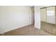 Bedroom featuring neutral carpet, an open entry doorway, closet with mirrored doors and natural light at 6603 Iona Rd, Indianapolis, IN 46203