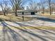 Charming single-story home featuring a gray brick exterior, attached garage, and a well-maintained front yard at 6603 Iona Rd, Indianapolis, IN 46203