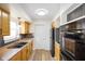 Efficient kitchen with stainless steel appliances, wood cabinets, and modern backsplash at 6603 Iona Rd, Indianapolis, IN 46203