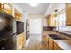 Functional kitchen with stainless appliances, wooden cabinets, and an eat-in space at 6603 Iona Rd, Indianapolis, IN 46203
