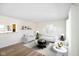 Open-concept living room with stylish furniture, modern decor, and wood flooring at 6603 Iona Rd, Indianapolis, IN 46203