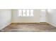 Clean and bright living room with wood-look floors, a view window, front door, and neutral decor at 6603 Iona Rd, Indianapolis, IN 46203