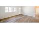 Bright living room featuring wood-look floors, a view window, front door, and freshly painted walls at 6603 Iona Rd, Indianapolis, IN 46203