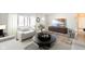 Comfortable living area with modern furniture, a large window, and a decorative entertainment center at 6603 Iona Rd, Indianapolis, IN 46203