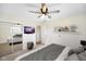 Spacious main bedroom with mirrored closet doors, a mounted TV, and neutral decor at 6603 Iona Rd, Indianapolis, IN 46203