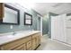 Bathroom featuring double sinks, framed mirrors, and neutral colored walls at 6655 Gopher Dr, Nineveh, IN 46164