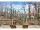 Enjoy the outdoor scenery from this wooden deck that is surrounded by trees and overlooks the water at 6655 Gopher Dr, Nineveh, IN 46164