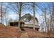 Exterior view of a unique dome home set on a hillside with an elevated deck and stairway at 6655 Gopher Dr, Nineveh, IN 46164