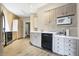Kitchen featuring updated appliances, light-colored cabinetry, and a sleek design with a view into the adjacent laundry area at 6655 Gopher Dr, Nineveh, IN 46164