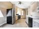 View of the kitchen showcasing stainless steel appliances and neutral-toned cabinets, complemented by a unique wood accent wall at 6655 Gopher Dr, Nineveh, IN 46164