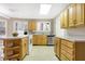 Functional kitchen with wooden cabinets, laminate countertops, and stainless steel appliances at 6655 Gopher Dr, Nineveh, IN 46164