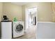Bright laundry room equipped with modern appliances and ample space, flowing into the kitchen area at 6655 Gopher Dr, Nineveh, IN 46164