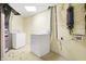Laundry room with washer and dryer units, mechanical components, and speckled tile floor at 6655 Gopher Dr, Nineveh, IN 46164