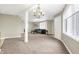 Large carpeted living room with neutral decor and a decorative chandelier at 6655 Gopher Dr, Nineveh, IN 46164