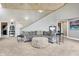Open living space with unique dome ceiling, neutral carpet, and staircase with railing at 6655 Gopher Dr, Nineveh, IN 46164