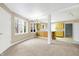 Open floor plan featuring an adjacent kitchen, neutral carpet, and ample natural light at 6655 Gopher Dr, Nineveh, IN 46164