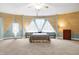 Spacious main bedroom featuring unique design, wooden accents, and a large triangular window, creating a bright and airy retreat at 6655 Gopher Dr, Nineveh, IN 46164