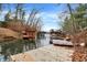 Waterfront view featuring a dock, wooden piers, and a tranquil lake setting under a blue sky at 6655 Gopher Dr, Nineveh, IN 46164