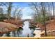 Picturesque waterfront showcasing docks, boats, and stunning architecture nestled between the trees at 6655 Gopher Dr, Nineveh, IN 46164