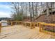 Wide angle view of an empty wood deck looking towards the lake and nearby trees at 6655 Gopher Dr, Nineveh, IN 46164