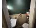 This half bathroom offers a sink and toilet with wallpaper, a towel rack, and a toilet paper rack at 721 Stover Ave, Indianapolis, IN 46227