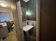 View of a laundry area with a pedestal sink and green wallpaper at 721 Stover Ave, Indianapolis, IN 46227