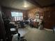 This is a home office with paneled walls, a window, a desk, overhead lighting, and carpeted floors at 721 Stover Ave, Indianapolis, IN 46227