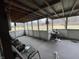 This is a covered porch with a concrete floor, screens, bare windows, and metal awning at 721 Stover Ave, Indianapolis, IN 46227