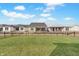 A sprawling backyard with lush grass and houses that show a welcoming neighborhood at 7256 Firestone Rd, Whitestown, IN 46075