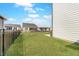 Backyard with a large grassy area and black fence at 7256 Firestone Rd, Whitestown, IN 46075
