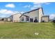 A large grassy backyard features a black fence and view of the home's exterior at 7256 Firestone Rd, Whitestown, IN 46075