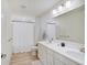 A bathroom with a double vanity and a shower and tub combo with white finishes at 7256 Firestone Rd, Whitestown, IN 46075
