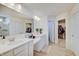Modern primary bathroom featuring double sinks, a walk-in shower, and a walk-in closet at 7256 Firestone Rd, Whitestown, IN 46075