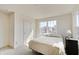 Bright bedroom with neutral carpet, walls, and window overlooking the neighborhood at 7256 Firestone Rd, Whitestown, IN 46075
