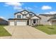 Beautiful two-story home showcasing a three-car garage and well-manicured lawn under a blue sky at 7256 Firestone Rd, Whitestown, IN 46075