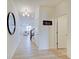 Bright entryway with wood laminate flooring, modern lighting, and a view into the living space at 7256 Firestone Rd, Whitestown, IN 46075