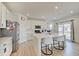 Modern kitchen featuring a breakfast bar with seating, stainless steel appliances, and white cabinetry at 7256 Firestone Rd, Whitestown, IN 46075