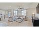 Spacious living area with large windows, comfortable seating, and an open flow to the kitchen at 7256 Firestone Rd, Whitestown, IN 46075