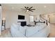 Open-concept living area with a large sofa, TV, and a view of the staircase at 7256 Firestone Rd, Whitestown, IN 46075