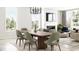 Elegant dining area with modern chandelier, stylish seating for six, and lots of natural light at 7310 Raybourn Ct, Indianapolis, IN 46259