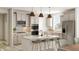 A beautifully designed kitchen featuring a large island, modern appliances, and stylish backsplash at 7310 Raybourn Ct, Indianapolis, IN 46259