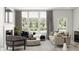 Bright living room with large windows, comfortable seating, and elegant decor at 7310 Raybourn Ct, Indianapolis, IN 46259