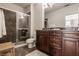 Bathroom with a glass-enclosed shower, dark wood cabinets, and a neutral color scheme for a clean aesthetic at 802 N Meridian St # 103, Indianapolis, IN 46204
